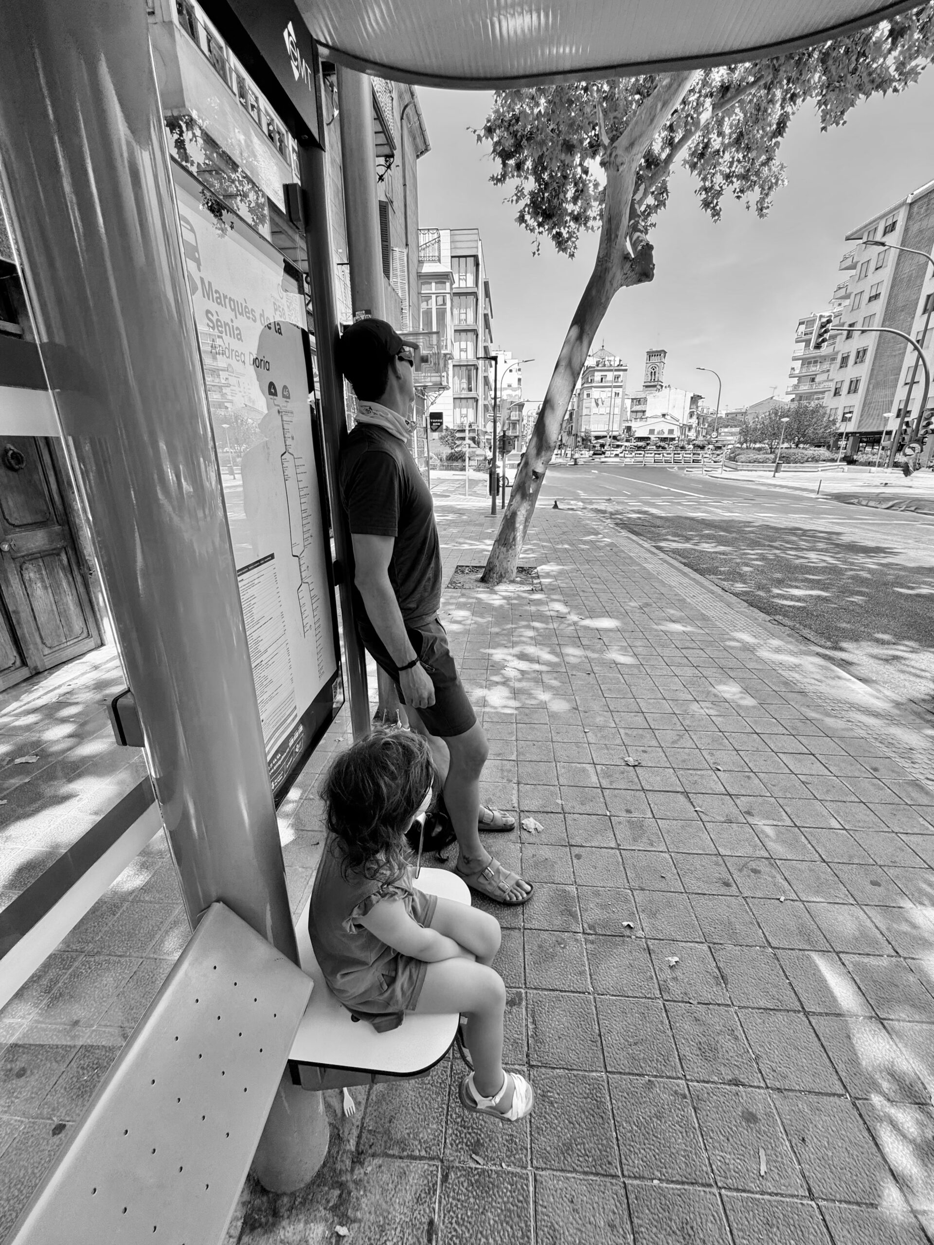 Garry and his daughter Coco at a bus stop in Palma