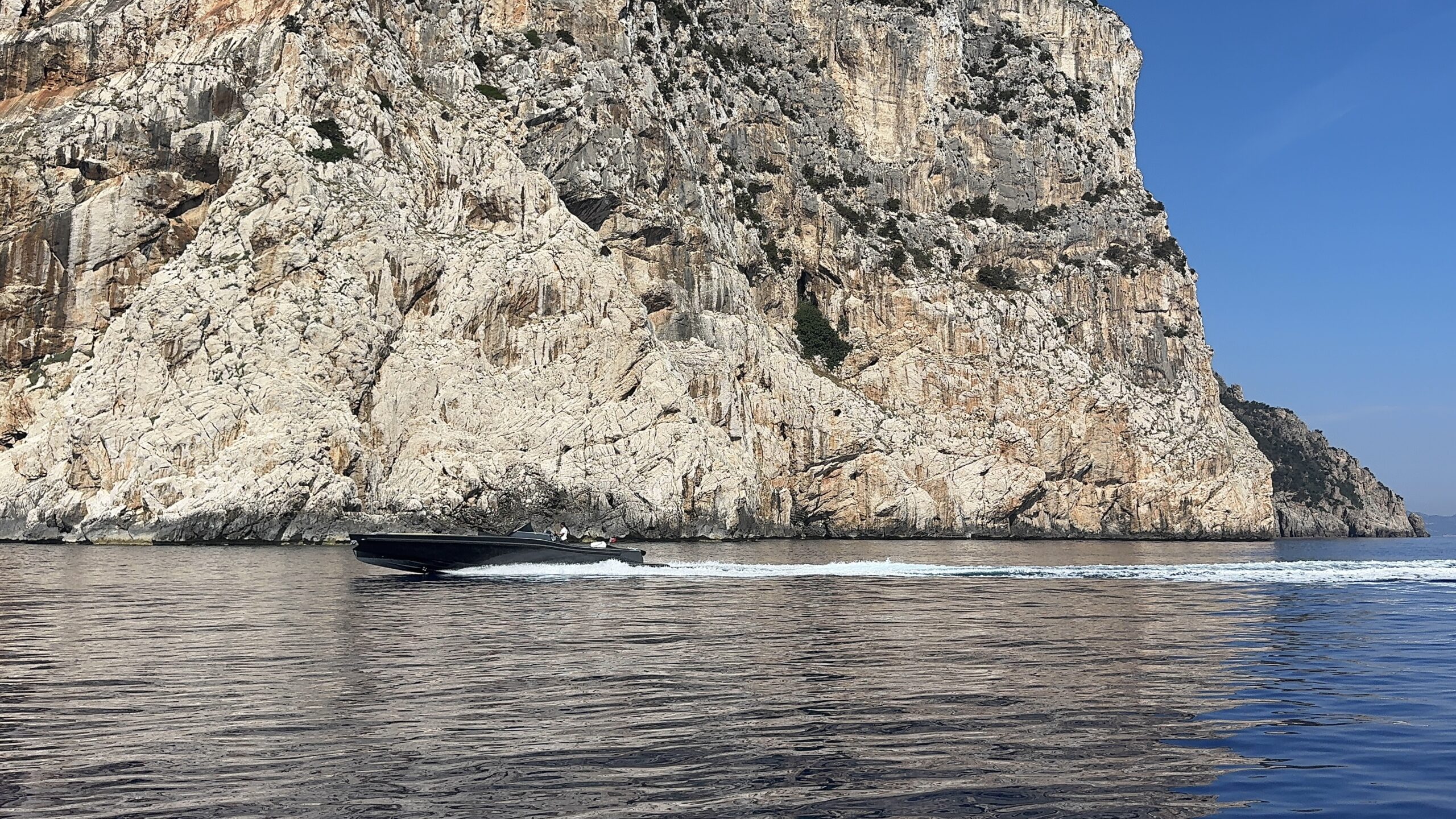 A tender running along Sardinia’s rugged northern coastline