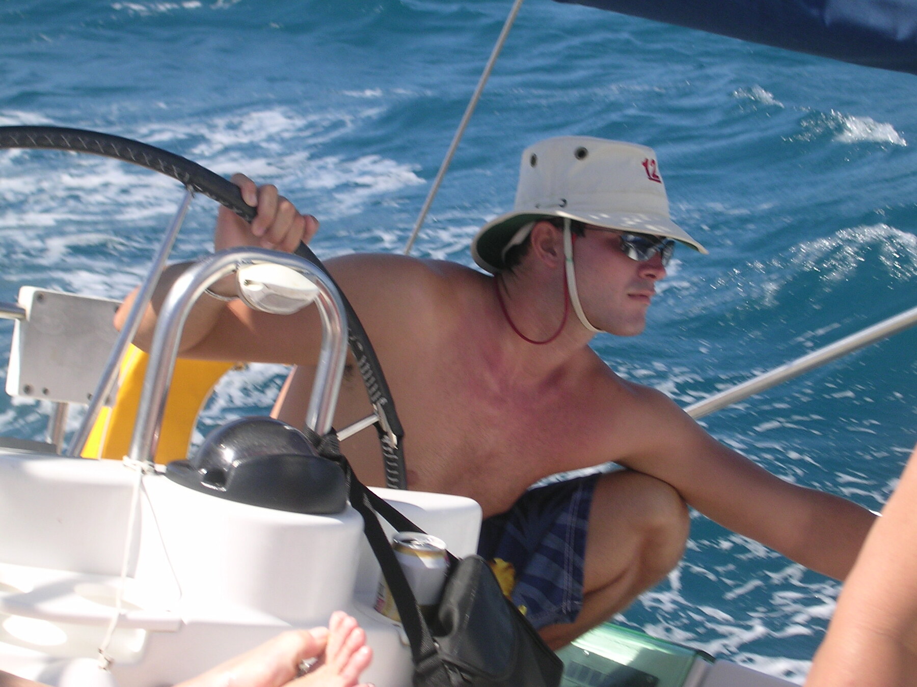 A young Garry at the helm of a sailboat in the British Virgin Islands, wearing a crew 12 shirt.
