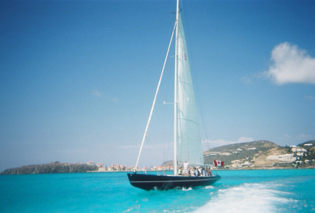 A 12 Metre yacht racing across turquoise water off Sint Maarten