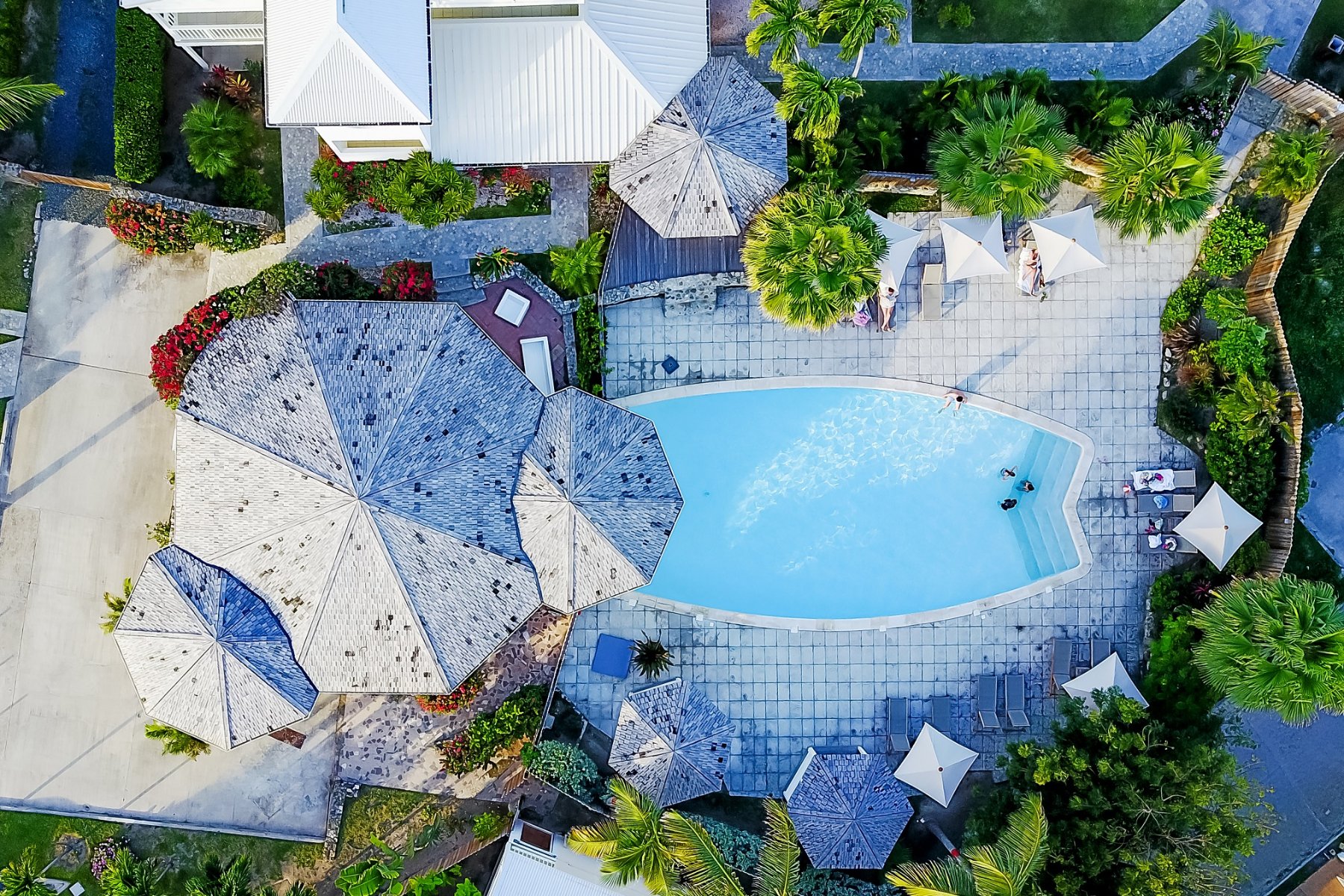 Aerial view of the pool and thatched roofs at La Playa Orient Bay hotel, Saint Martin.
